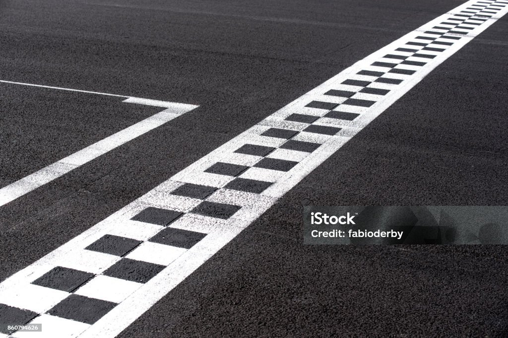 Concept of goal, success, achievement Checkered finish line on asphalt motorsport racing track concept of goal, achievement, success Finish Line Stock Photo