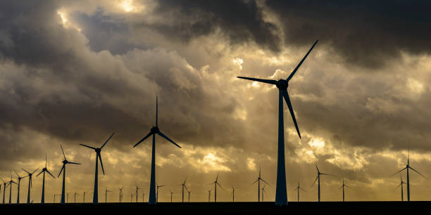 istock Wind turbines on land and offshore in a storm 860797450