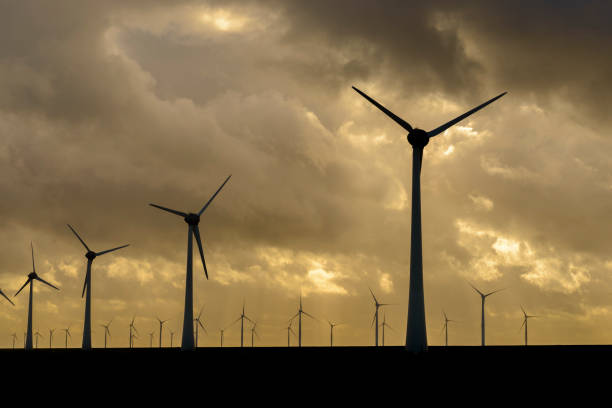 istock Wind turbines on land and offshore in a storm 860797750
