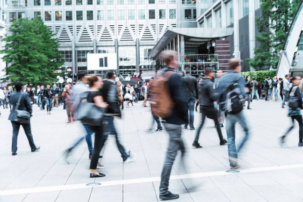 Blurred People walking in front of Modern Office Buildings Canary Whar, London's Financial District, England london docklands stock pictures, royalty-free photos & images