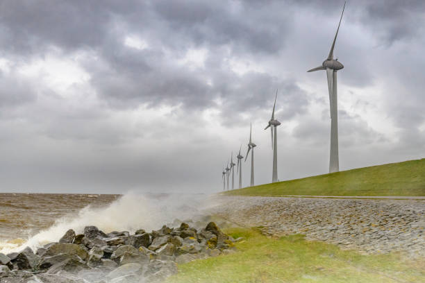 istock Wind turbines on land and offshore in a storm 860801058