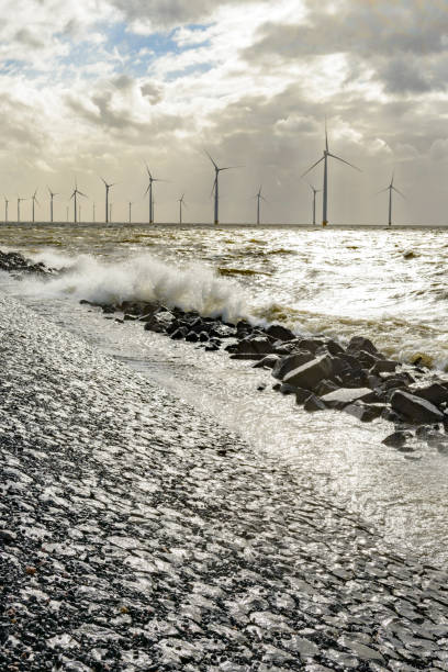 istock Wind turbines on land and offshore in a storm 860802042