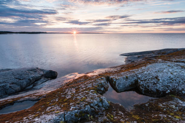 istock Sunrise on lake with stony coast landscape 860808600