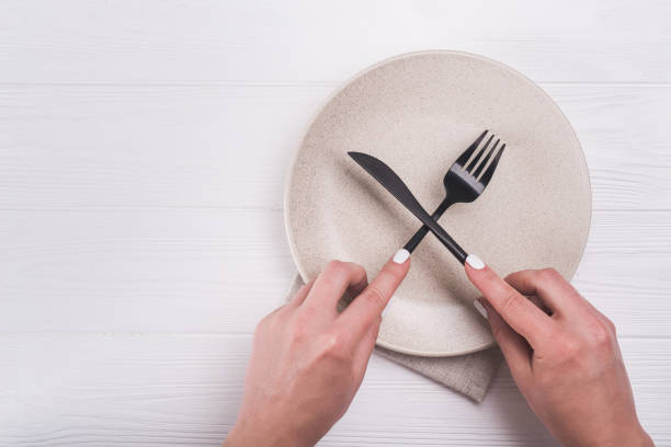 istock woman hand with knife and fork 860812134