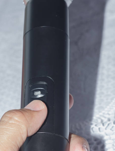 istock Hand press the power button on the microphone. 860814000