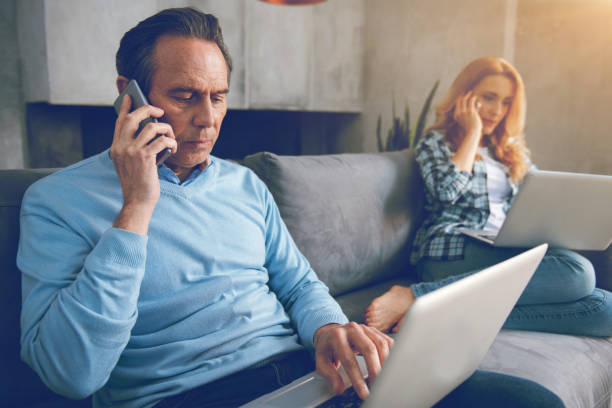 istock Mature couple busy working from home 860816456