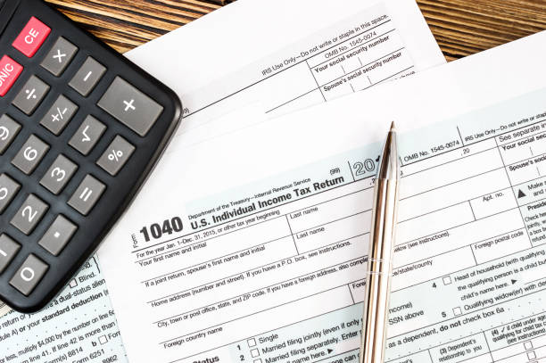 istock Tax form with calculator and pen on the table. 860816802