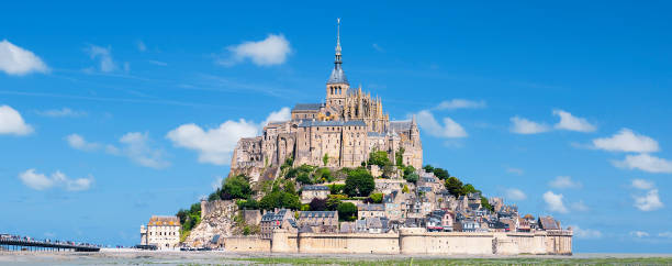 istock Mont-Saint-Michel and green grass 860818080