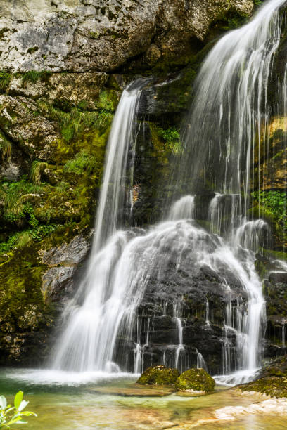 istock Beautiful natural waterfall falling over rocks 860818118