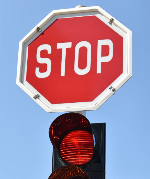 istock Stop sign and red light at the road crossing 860822264