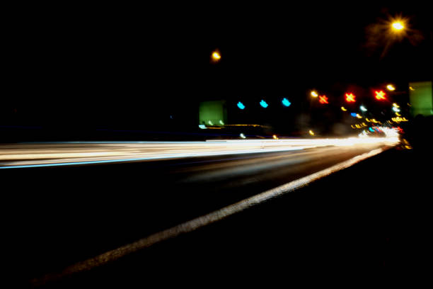 Blurry Illumination and night lights, car traffic motion blur the speed and dynamics
