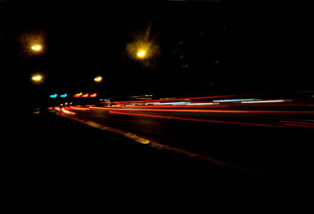 Blurry Illumination and night lights, car traffic motion blur the speed and dynamics