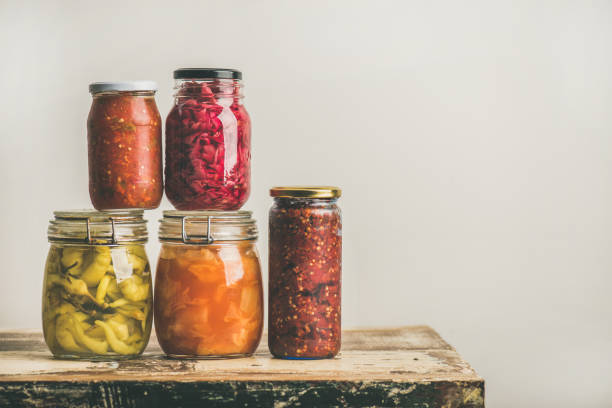 istock Autumn seasonal pickled or fermented vegetables in jars, copy space 860826626