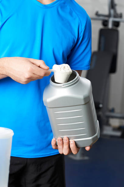 istock Man In Gym Taking Nutritional Supplement 860826674