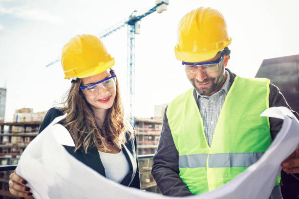 istock Portrait of two engineers looking at a whiteprint plan 860830176