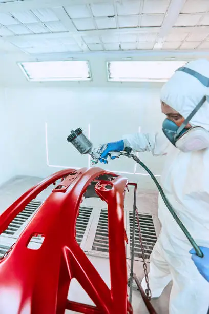 Photo of Painting bumpers machine red in the paint shop.