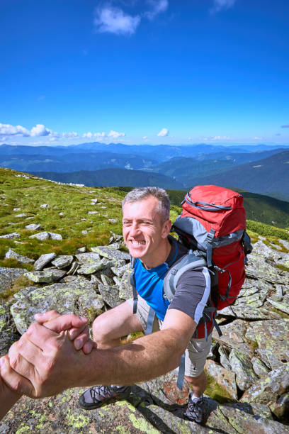 istock Help, support and help in a dangerous situation to hike in the mountains. 860833834