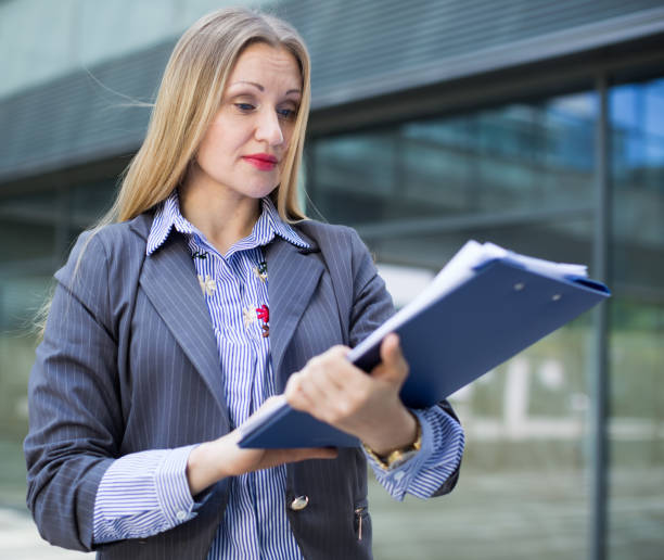 istock Adult female architect with paper documents 860838060