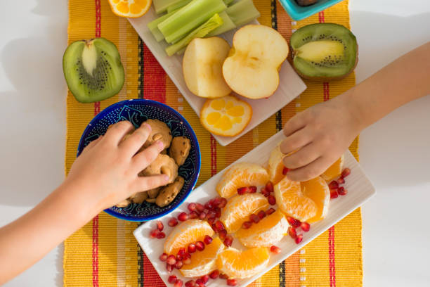 Heathy fruits for kids Fruits on the table, and kids hands heathy stock pictures, royalty-free photos & images