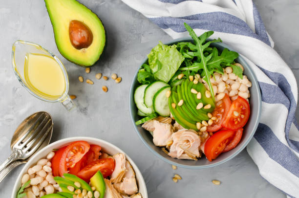 istock Salmon with white bean, tomatoes, cucumbers, avocado and arugula salad 860850780
