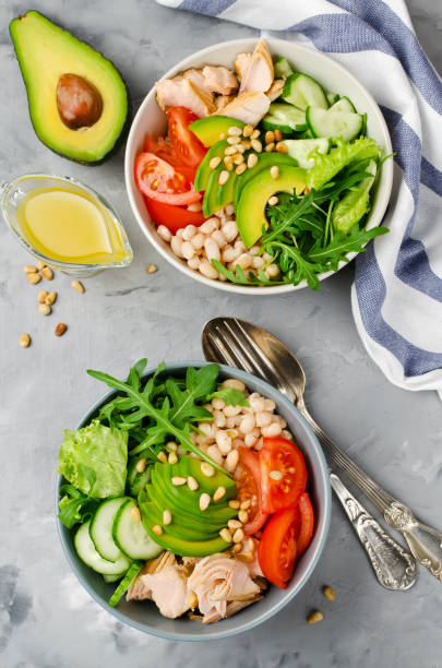 istock Salmon with white bean, tomatoes, cucumbers, avocado and arugula salad 860850798