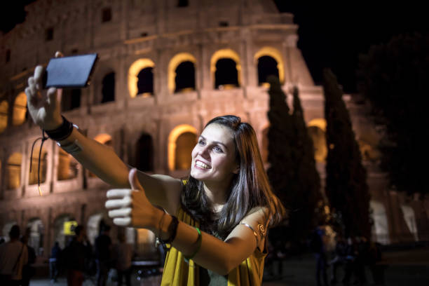 istock Smiling young woman taking selfie in Rome 860860256