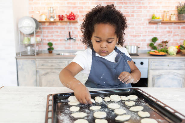 istock Little girl preparing homemade biscuits 860860614