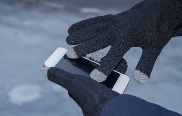 istock The hands in gloves hold the phone 860866148