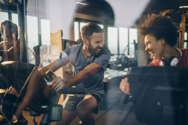 istock Happy athletes communicating and laughing while exercising in a gym together. 860866680