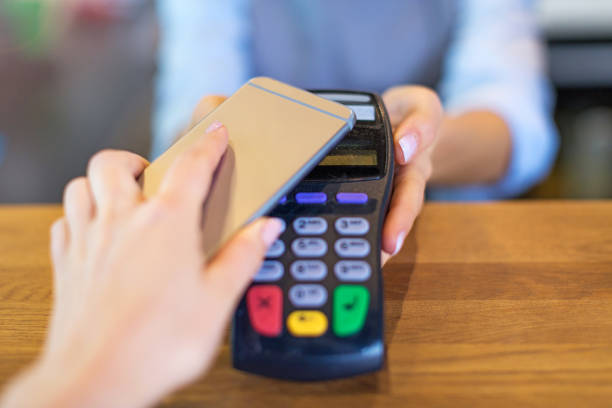 istock Customer Paying Through Mobile Phone In Cafe 860869394