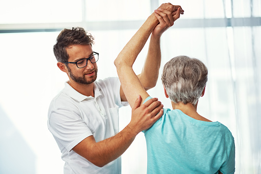 Cropped shot of a senior woman working through her recovery with a male physiotherapist