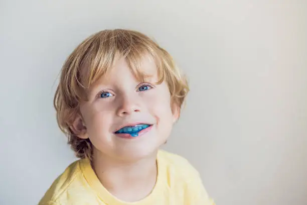 Three-year old boy shows myofunctional trainer. Helps equalize the growing teeth and correct bite, develop mouth breathing habit. Corrects the position of the tongue.