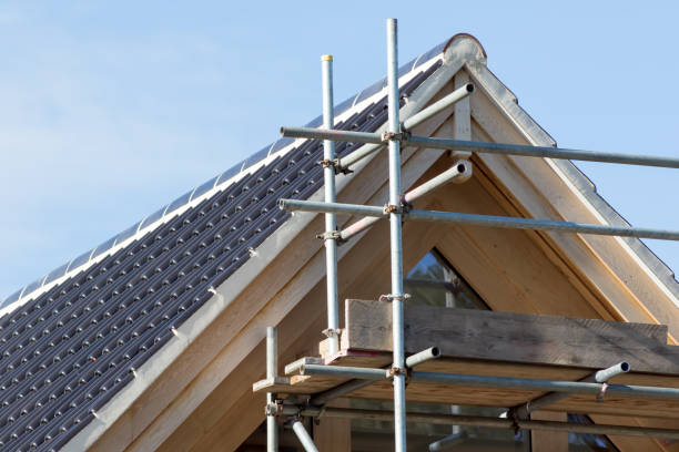 istock Modern house roof construction. Black curved ceramic tiles with scaffolding. 860873360