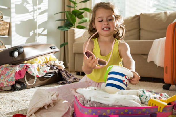 istock Little girl packing suitcase 860876780