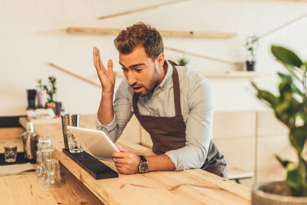 istock barista using tablet in coffee shop 860877282