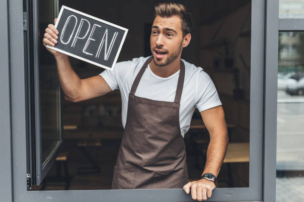 istock waiter holding chalkboard with open word 860877396