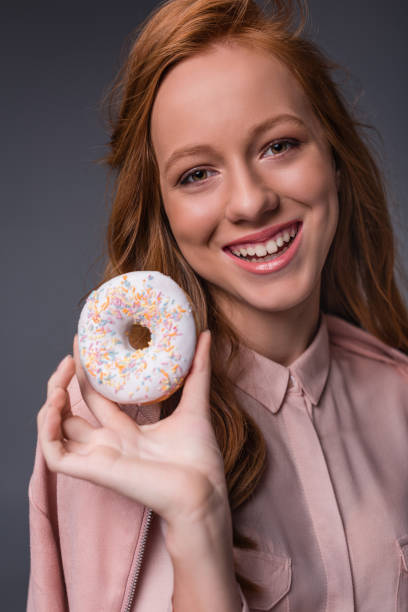 istock redhead girl with donut 860880236