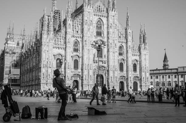 Singer artist are playing in the morning in Piazza Duomo in Milan, other people and tourists are moving