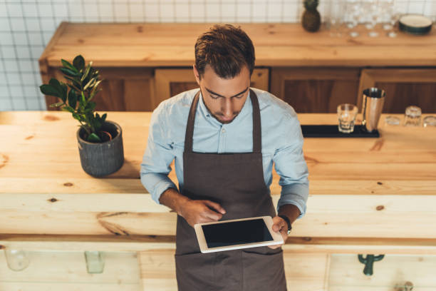 istock barista using tablet in coffee shop 860883936
