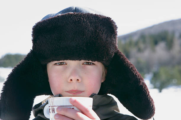 little boy with chpaka, drinking hot chocolate in  - 24120 ストックフォトと画像