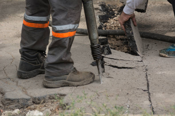 istock A male worker removes the asphalt with his hands 860888896