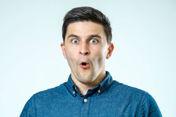 istock Portrait of a young beautiful man with surprised face expression over gray 860892002