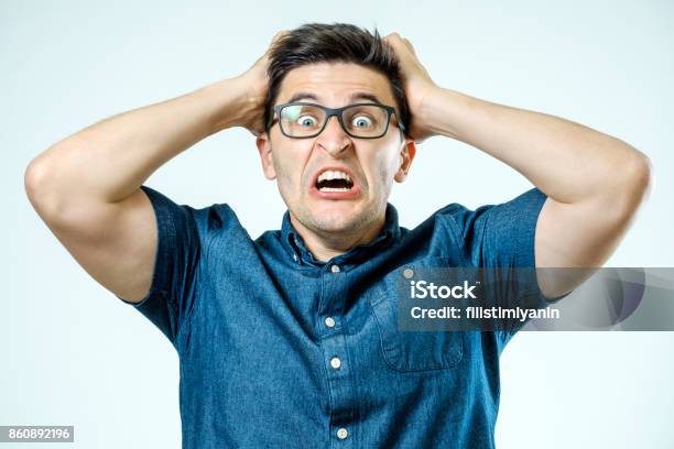 Man With Shocked Amazed Expression Isolated On Gray Background Stock Photo - Download Image Now