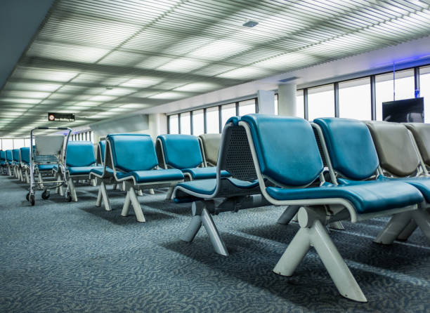 istock Empty chairs at the airport terminal lobby 860892998