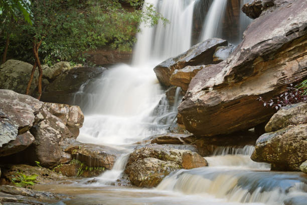 istock Turbid water at the waterfall with stone slide and danger 860895212