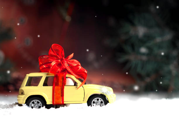 istock small car with a decorative bow in snow 860919966