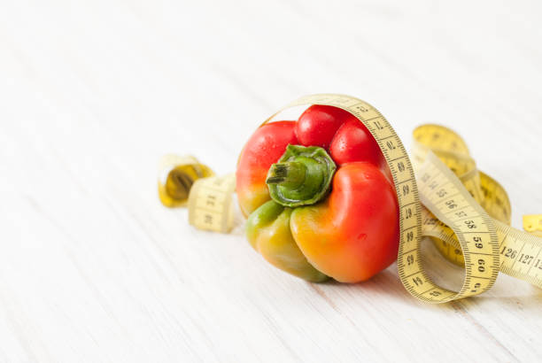 Ingredients to prepare fresh vegetable salads on a white table. Proper nutrition for weight loss. The place to insert the text.