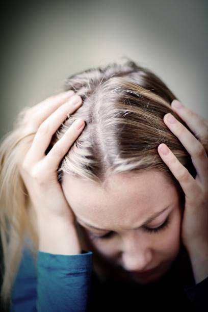 istock Young Woman Suffering From Depression With Head In Hands 860927606