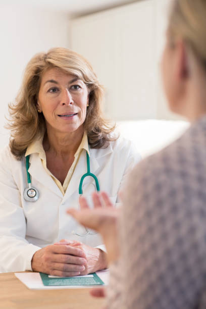 istock Doctor Discussing Leaflet With Female Patient 860927826