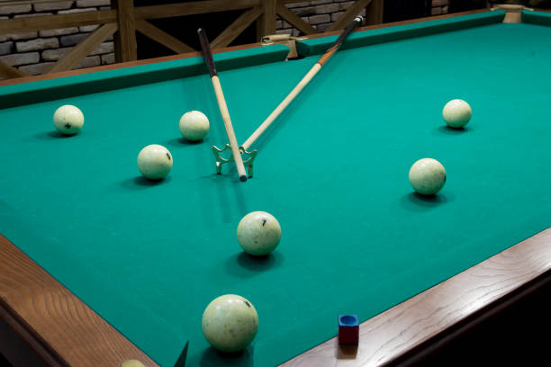 istock Billiard table with white balls and cue view from  corner 860930398